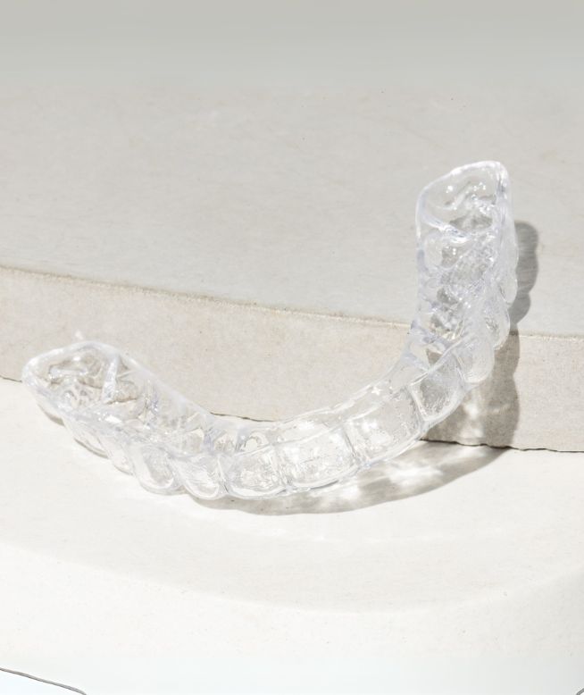 Chomper Labs Hybrid night mouth guard displayed on pedestal.