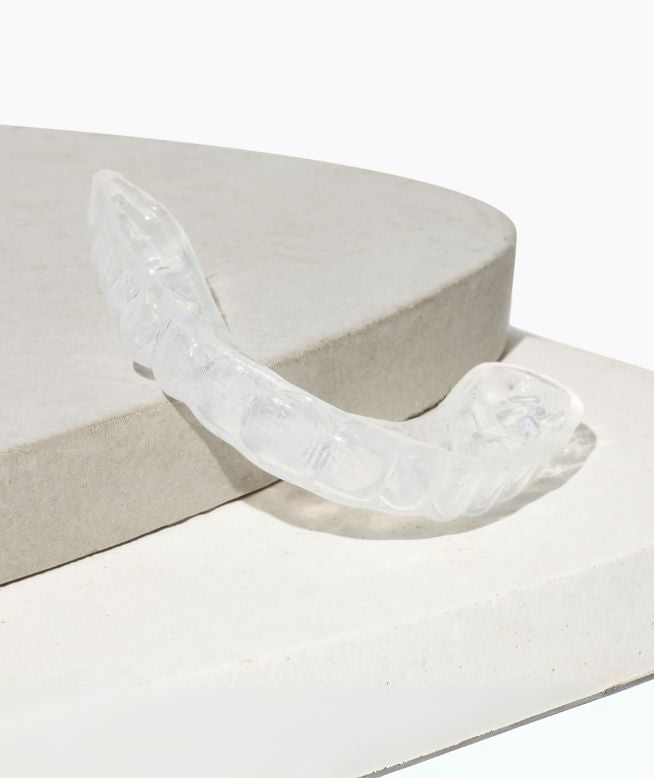 Chomper Labs Soft night guard displayed on pedestal.