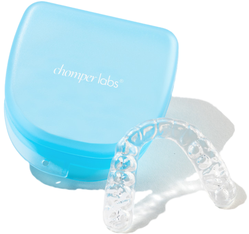 Chomper Labs night guard resting on blue container case.