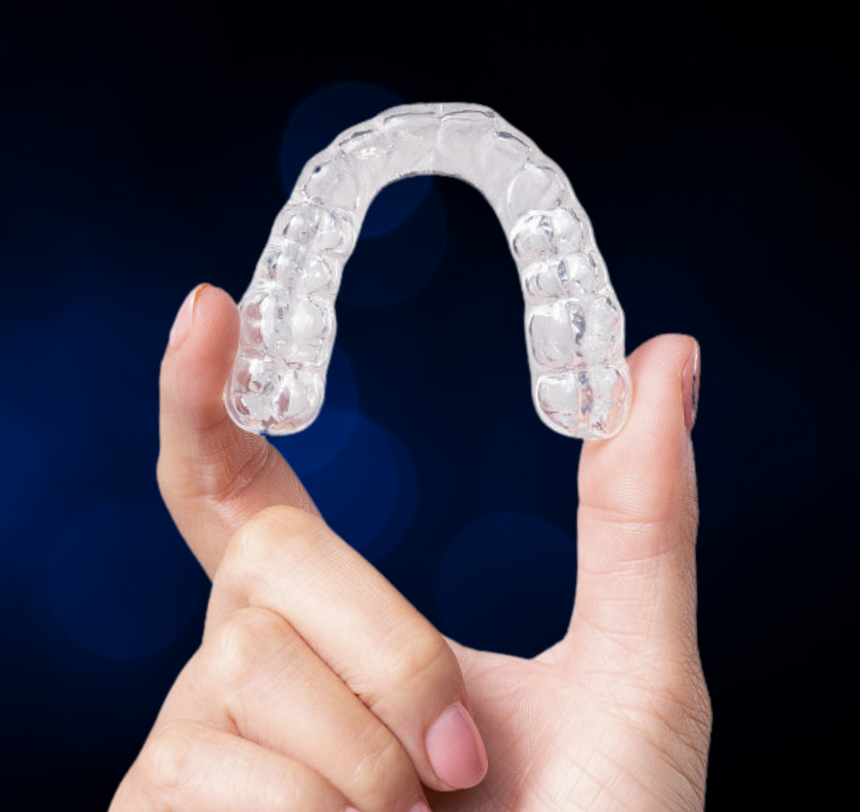 Chomper Labs night guard being held in person's hand.